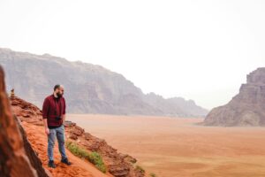 Photographer standing on cliff in Wadi Rum