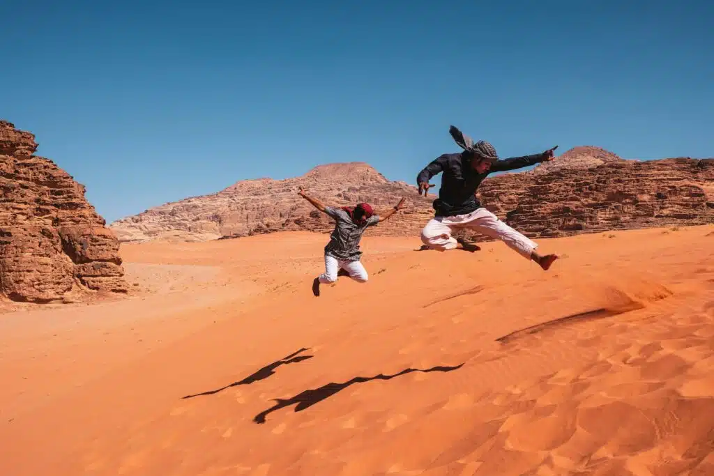 Wadi Rum bedouins jumping in the desert